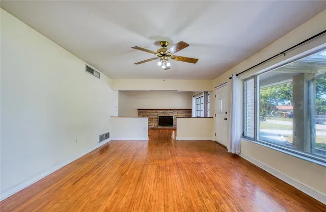 a kitchen with a refrigerator and white cabinets