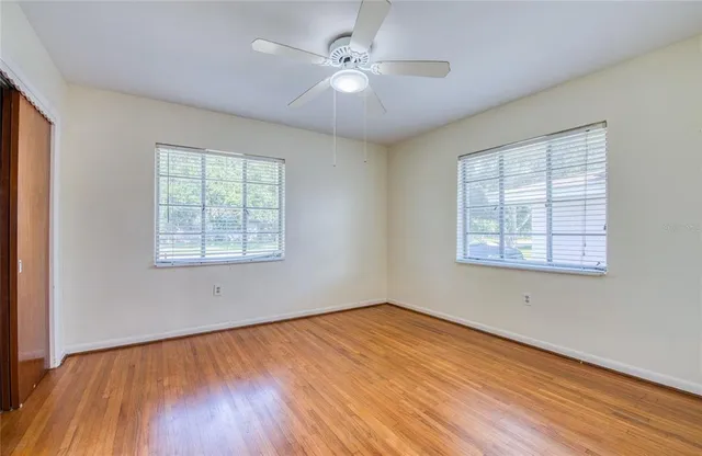 wooden floor in an empty room with a window