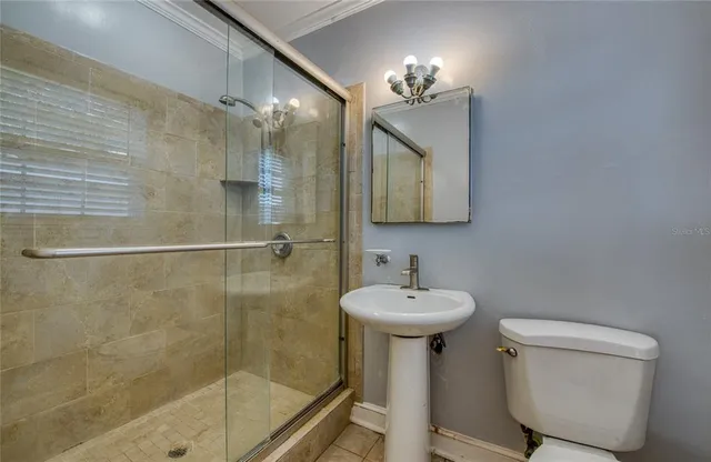a bathroom with a sink toilet and mirror