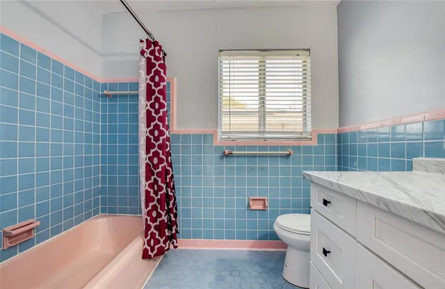 a bathroom with a toilet sink and shower