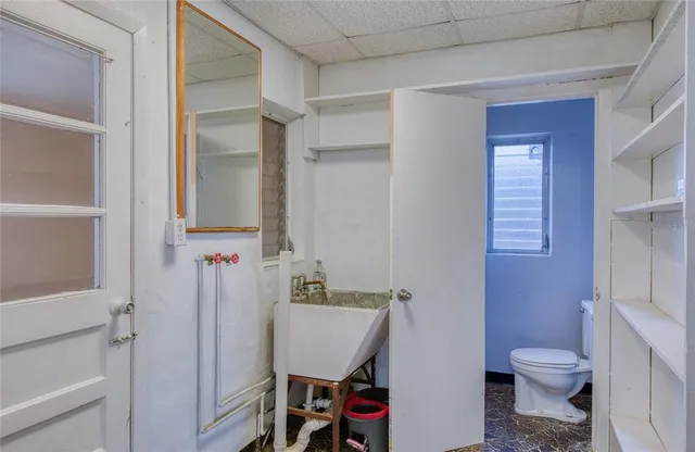 a bathroom with a black and white checkered floor