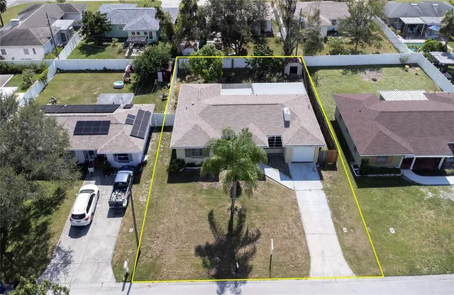 an aerial view of a house with a swimming pool patio and lake view