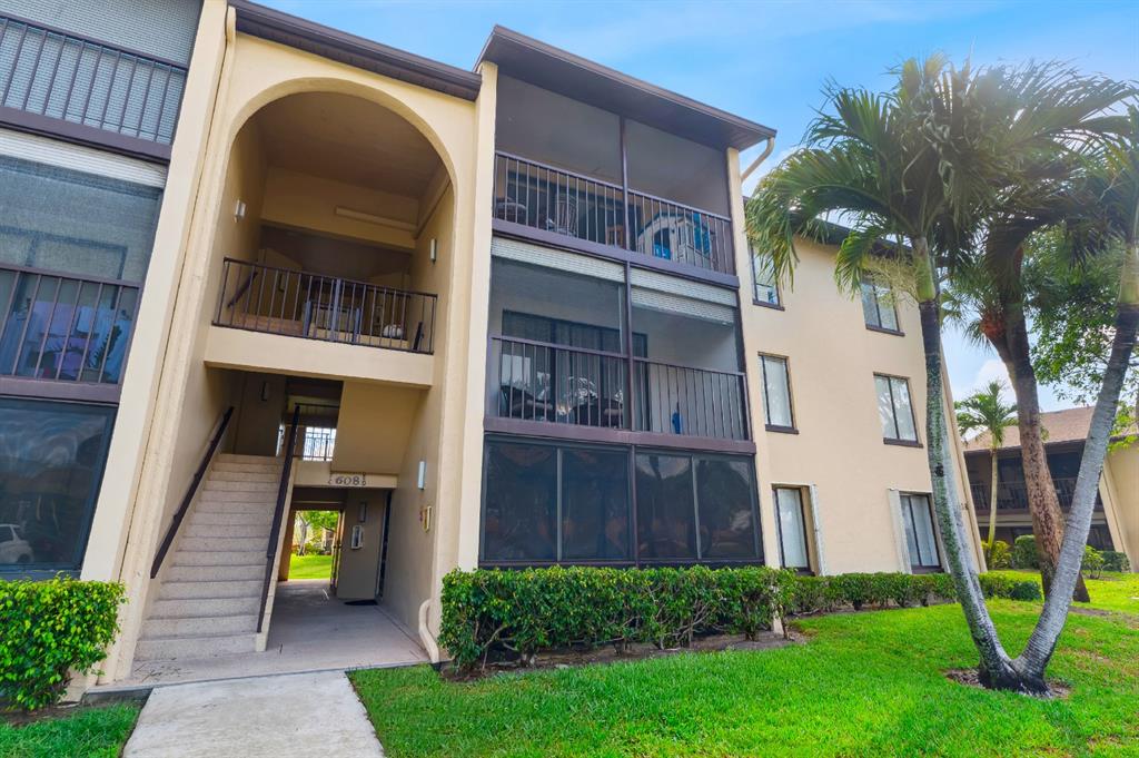 608 Sea Pine Way, Unit D2 Greenacres, FL 33415 - Photo 11 of 13 a view of front door of house with yard