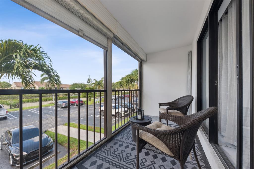 608 Sea Pine Way, Unit D2 Greenacres, FL 33415 - Photo 12 of 13 a view of a balcony with furniture