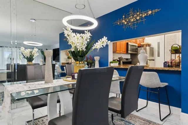 a living room with furniture a chandelier and a piano