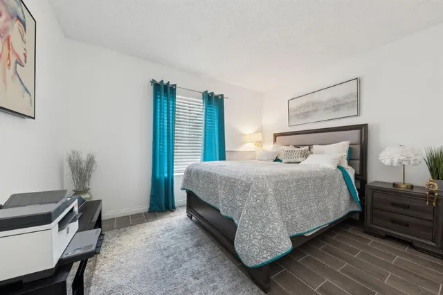 a bedroom with a bed and a desk