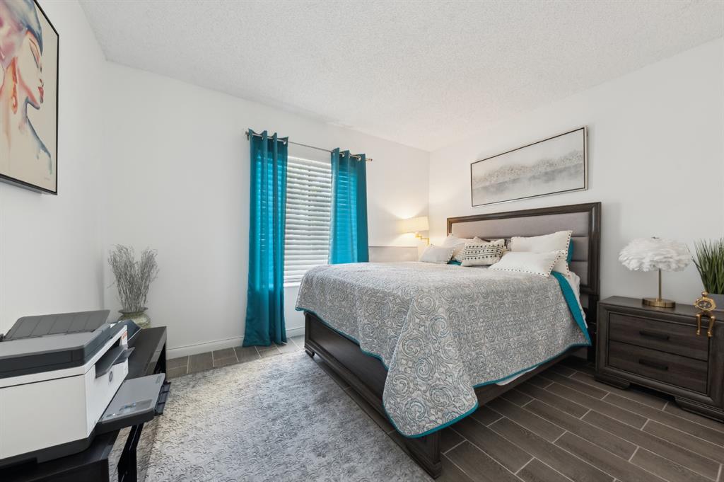 608 Sea Pine Way, Unit D2 Greenacres, FL 33415 - Photo 9 of 13 a bedroom with a bed and a desk