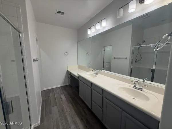 a bathroom with a double vanity sink and mirror