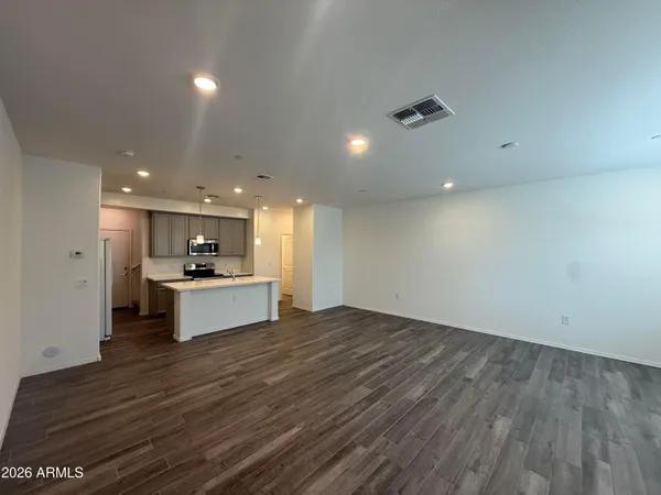 a large kitchen with kitchen island a sink stainless steel appliances and cabinets
