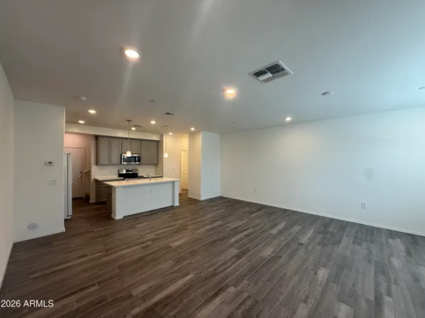 a large kitchen with kitchen island a sink stainless steel appliances and cabinets