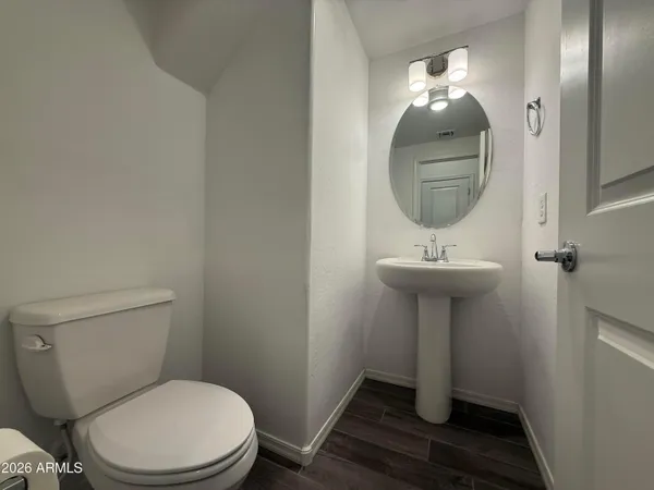 a bathroom with a sink toilet and mirror