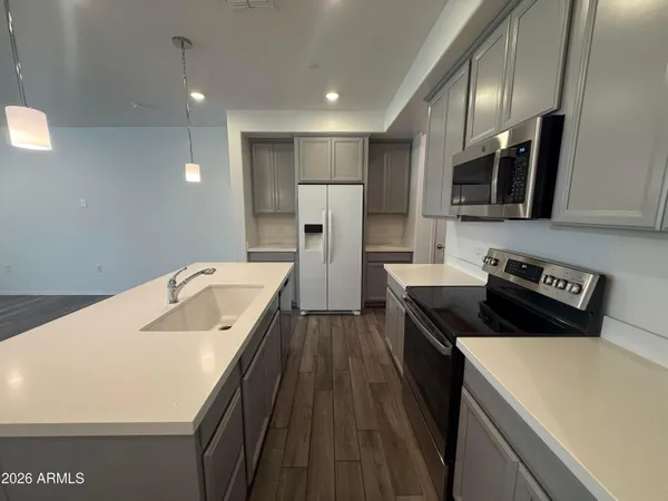 a kitchen with a sink a stove and refrigerator