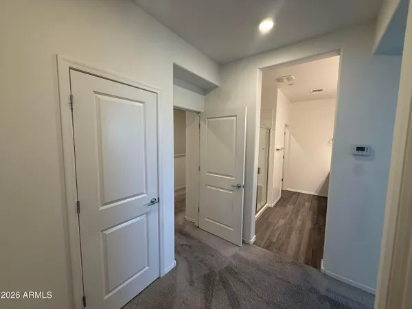 a view of a hallway with wooden floor