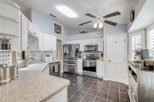 a view of a a dining room with furniture and a large window