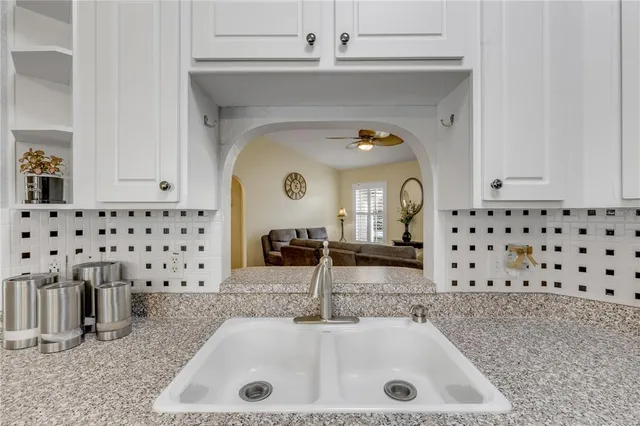 a en suite bathroom with a granite countertop sink mirror and