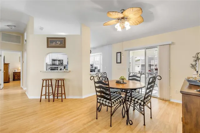a view of a swimming pool with a yard and large trees