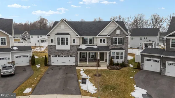 a view of a house with a cars park side of road