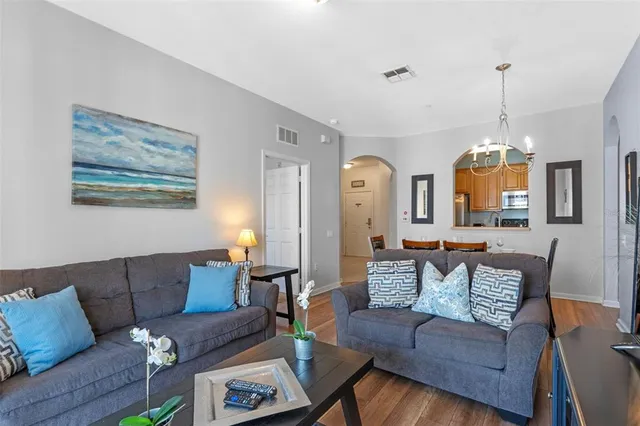a living room with furniture chandelier and couch