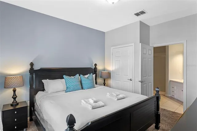 a bedroom with a bed and a night stand