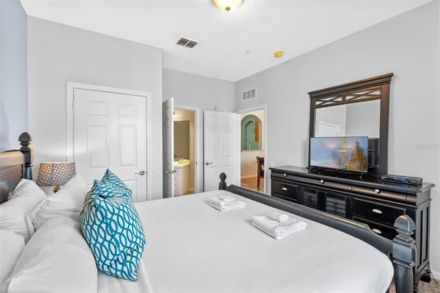 a bedroom with a bed and a flat screen tv