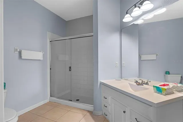 a bathroom with a sink vanity granite and shower