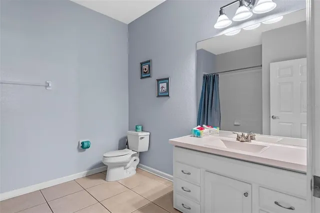 a bathroom with a sink toilet and a mirror