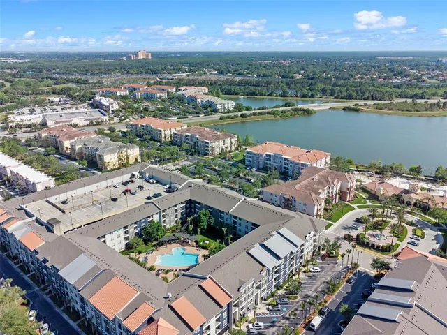 an aerial view of a residential building and lake view