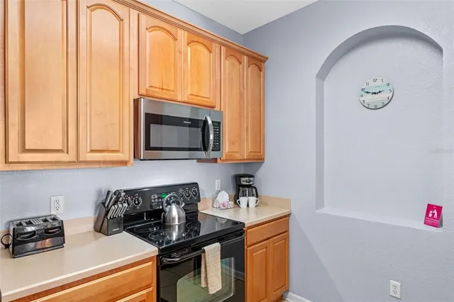 a kitchen with a sink a stove and cabinets