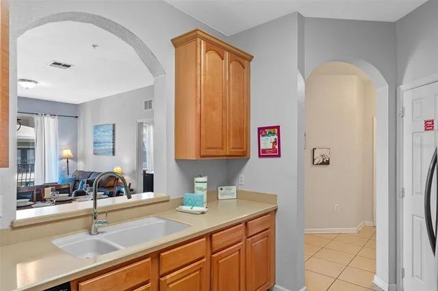 a kitchen with a sink cabinets and a window