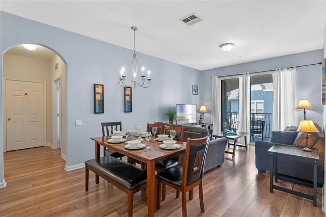a view of a dining room with furniture and wooden floor