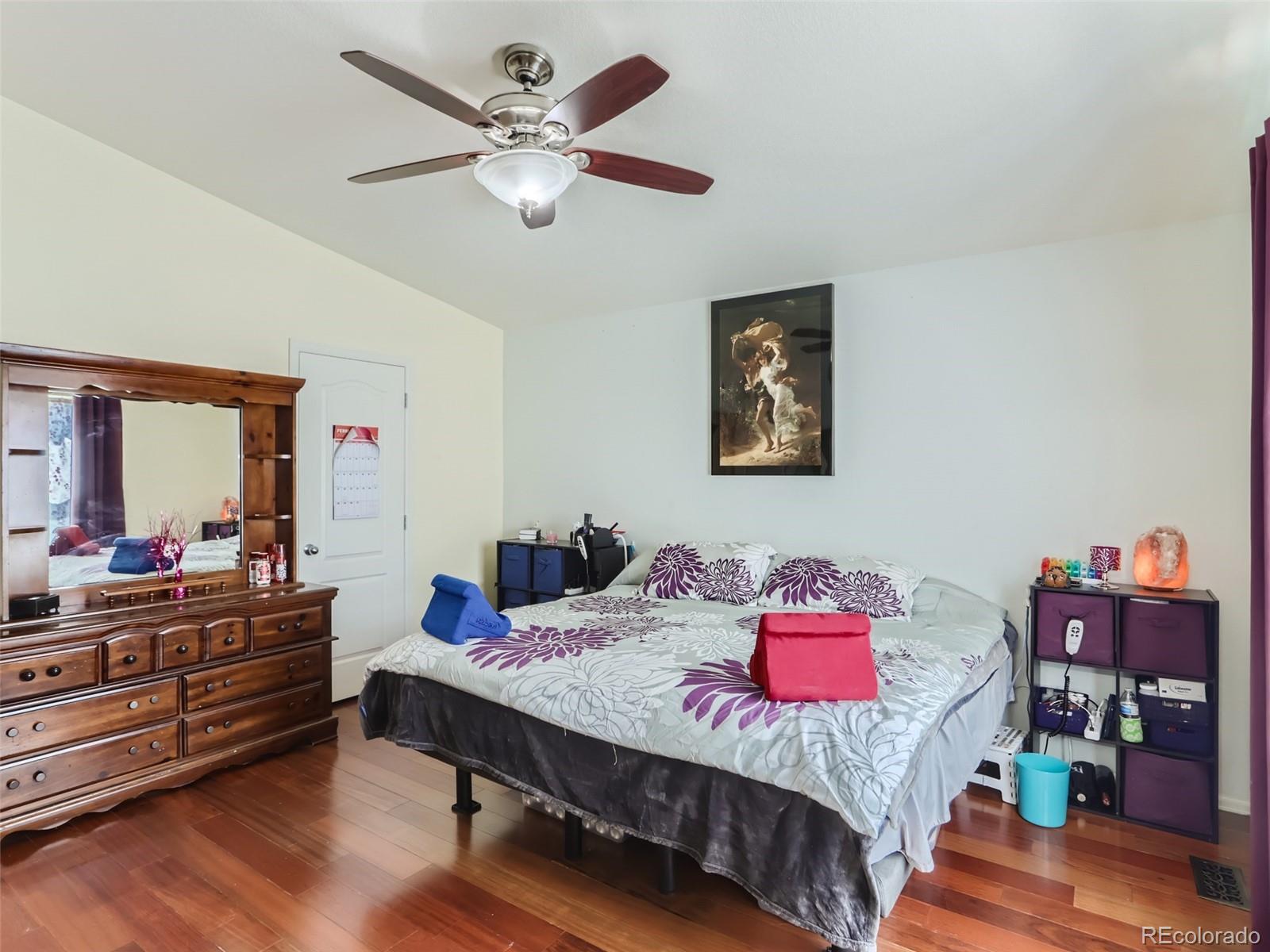 8080 Raspberry Drive Frederick, CO 80504 - Photo 12 of 29 a bedroom with a bed and a chandelier