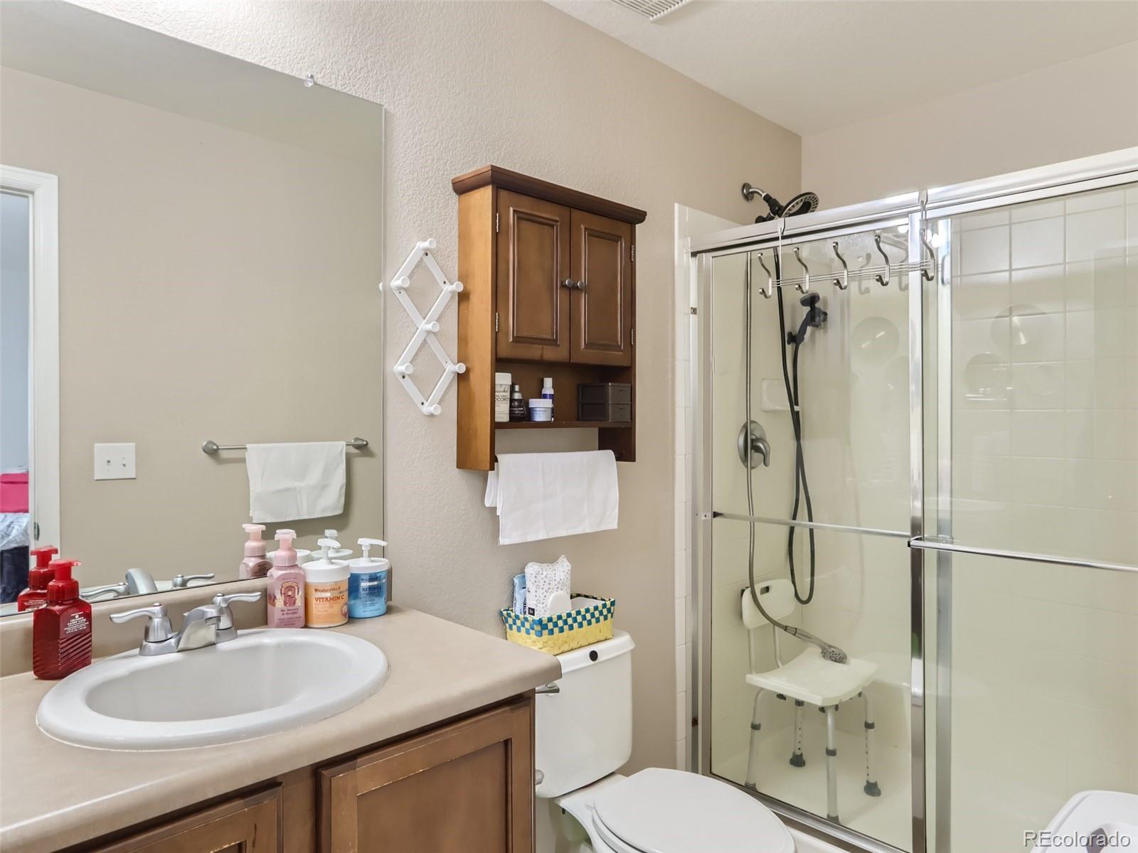 8080 Raspberry Drive Frederick, CO 80504 - Photo 13 of 29 a bathroom with a sink toilet and shower