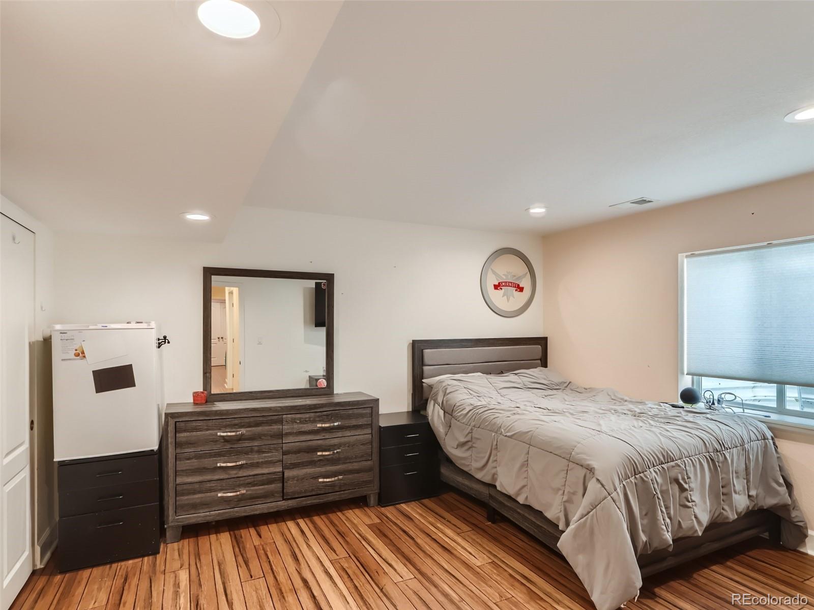 8080 Raspberry Drive Frederick, CO 80504 - Photo 17 of 29 a bedroom with a bed and a dresser