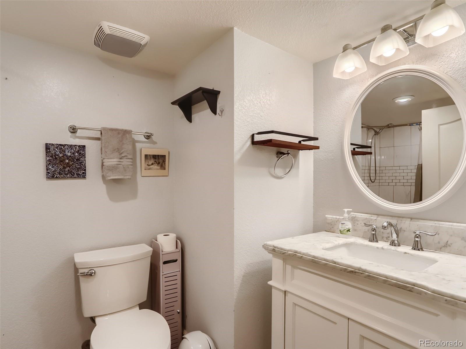 8080 Raspberry Drive Frederick, CO 80504 - Photo 20 of 29 a bathroom with a granite countertop toilet sink and mirror