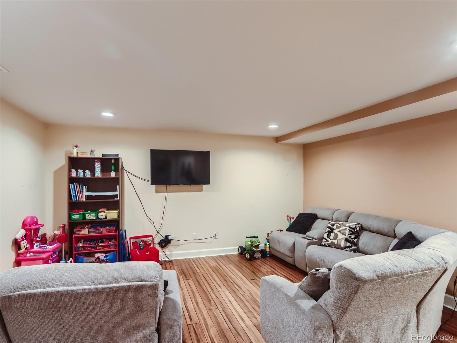 8080 Raspberry Drive Frederick, CO 80504 - Photo 21 of 29 a bedroom with furniture and a flat screen tv