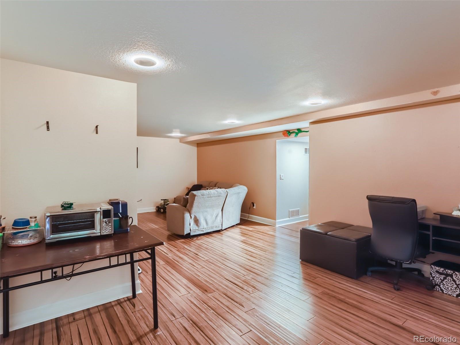 8080 Raspberry Drive Frederick, CO 80504 - Photo 22 of 29 a workspace with furniture and wooden floor