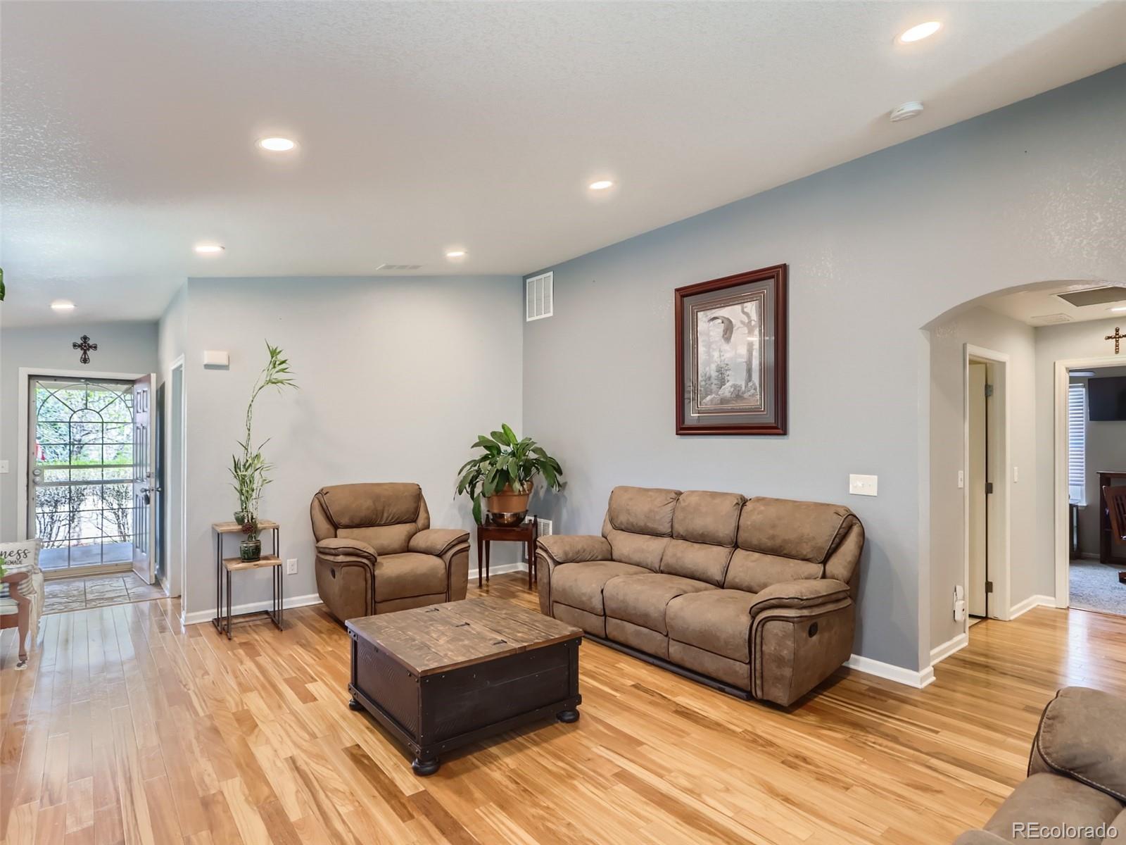 8080 Raspberry Drive Frederick, CO 80504 - Photo 5 of 29 a living room with furniture and wooden floor