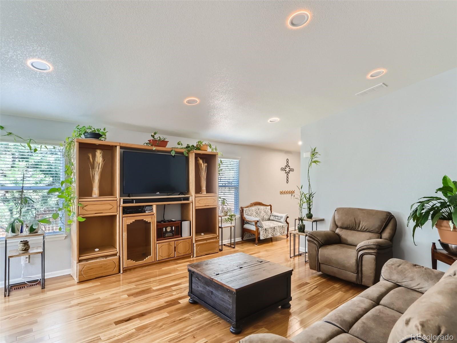 8080 Raspberry Drive Frederick, CO 80504 - Photo 6 of 29 a living room with furniture and a flat screen tv
