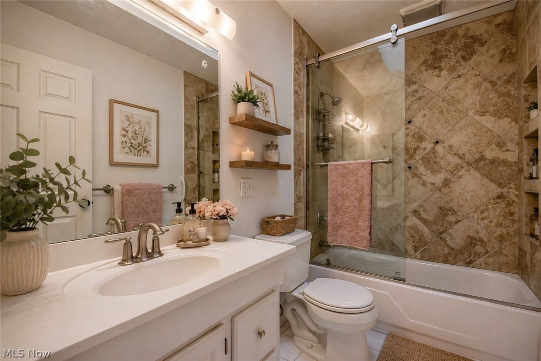 8242 Starburst Road Mentor, OH 44060 - Photo 15 of 37 Bathroom featuring a white vanity with an integrated sink, brushed nickel faucet, and a large wall mirror