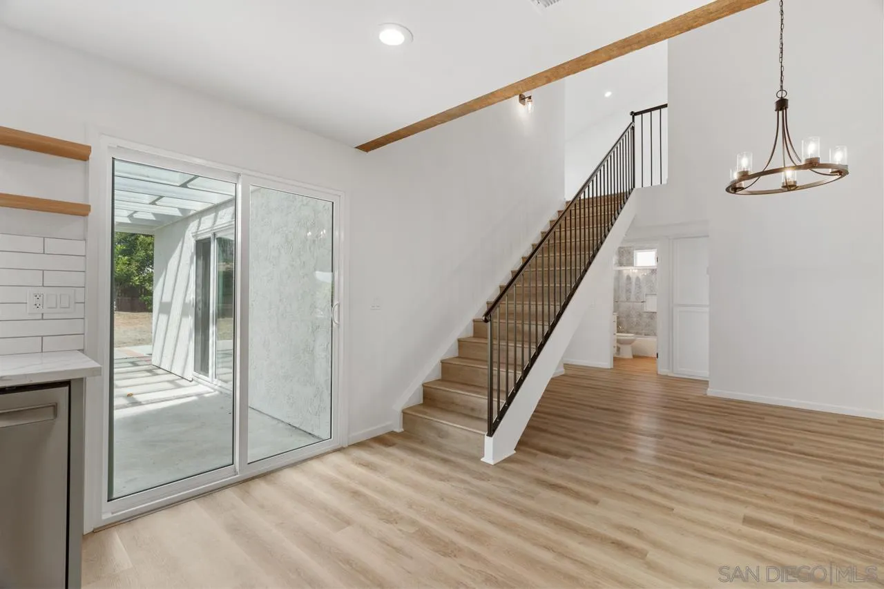 1706 Catalpa Road Carlsbad, CA 92011 - Photo 15 of 41 a view of a hallway with wooden floor and staircase