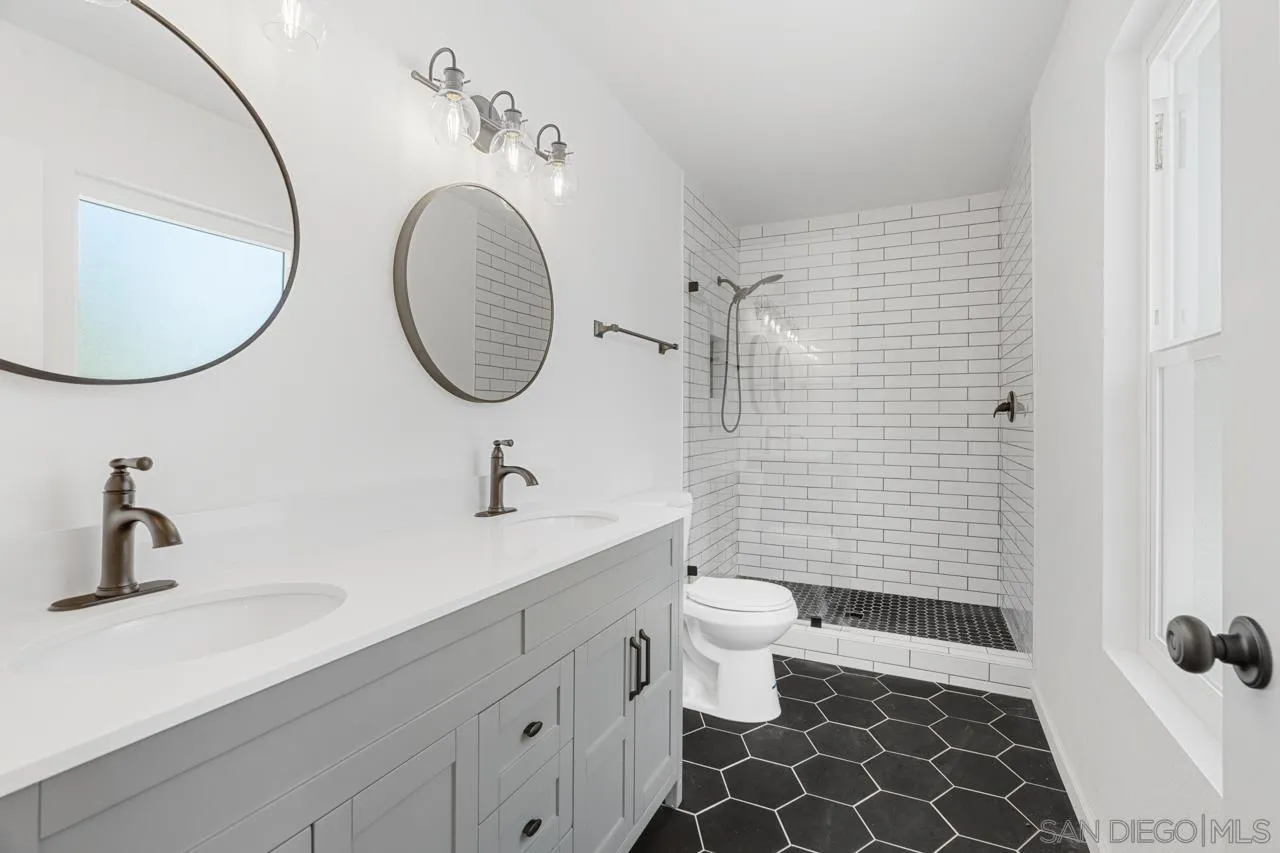 1706 Catalpa Road Carlsbad, CA 92011 - Photo 17 of 41 a bathroom with a sink a toilet and a mirror