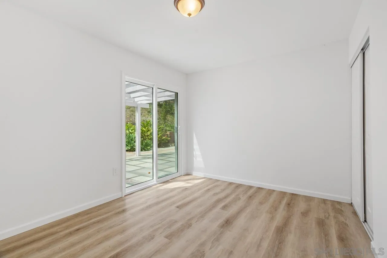 1706 Catalpa Road Carlsbad, CA 92011 - Photo 20 of 41 a view of an empty room with wooden floor and a window