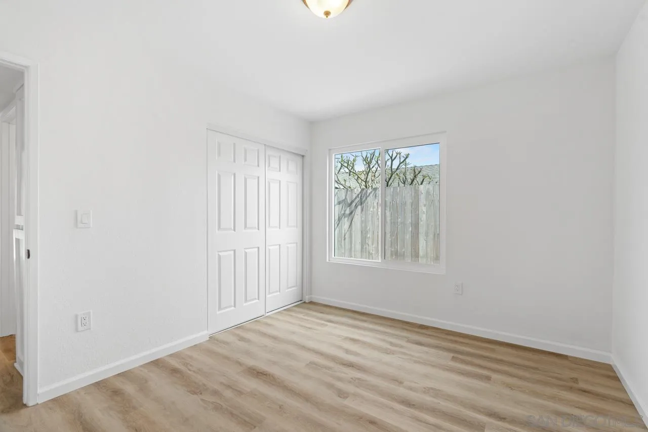 1706 Catalpa Road Carlsbad, CA 92011 - Photo 23 of 41 an empty room with wooden floor and windows