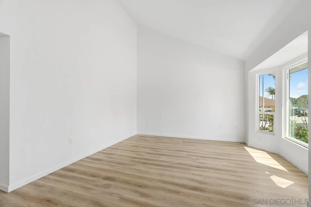 1706 Catalpa Road Carlsbad, CA 92011 - Photo 5 of 41 a view of an empty room with wooden floor and a window