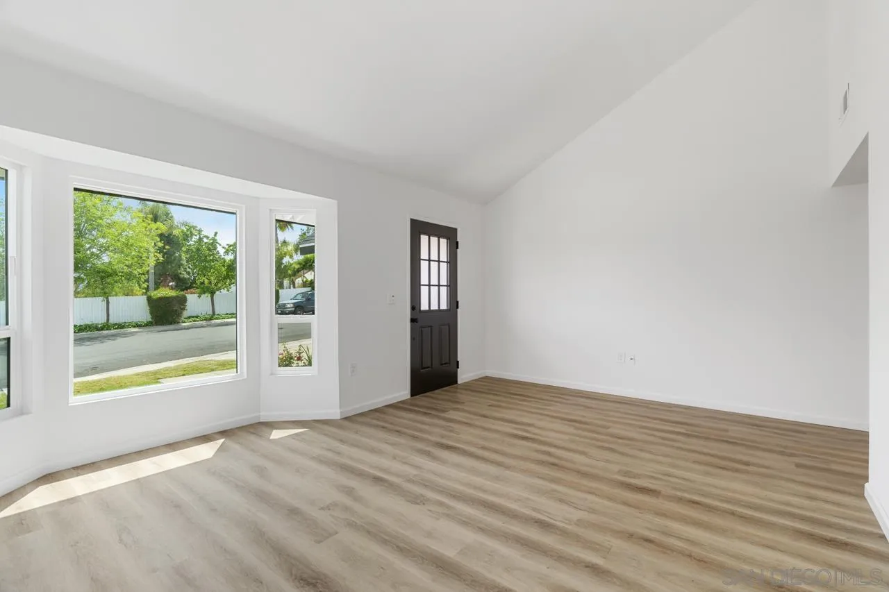 1706 Catalpa Road Carlsbad, CA 92011 - Photo 6 of 41 a view of an empty room with wooden floor and a window