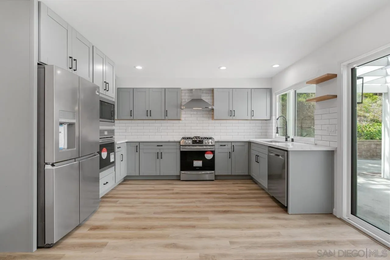 1706 Catalpa Road Carlsbad, CA 92011 - Photo 9 of 41 a kitchen with stainless steel appliances granite countertop a refrigerator and a sink