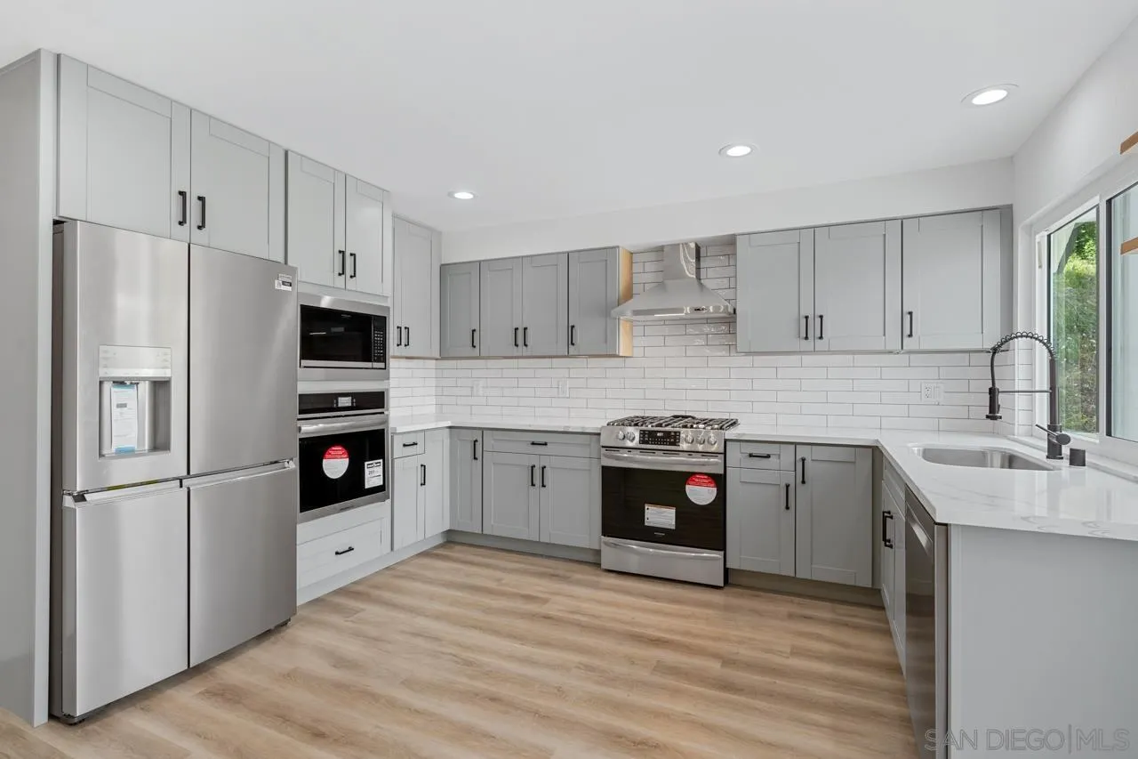 1706 Catalpa Road Carlsbad, CA 92011 - Photo 10 of 41 a kitchen with stainless steel appliances granite countertop a refrigerator stove and sink