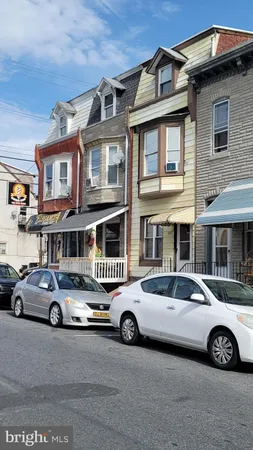 a car parked in front of a big house