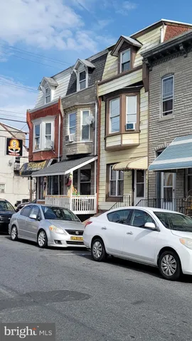 a car parked in front of a big house