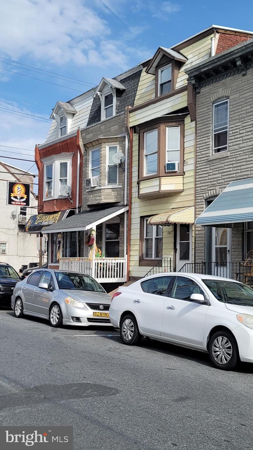a car parked in front of a big house